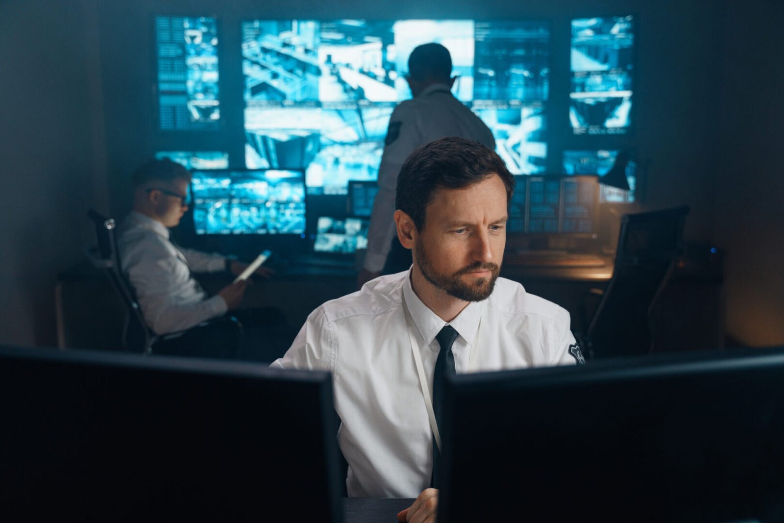 People in control room with monitors