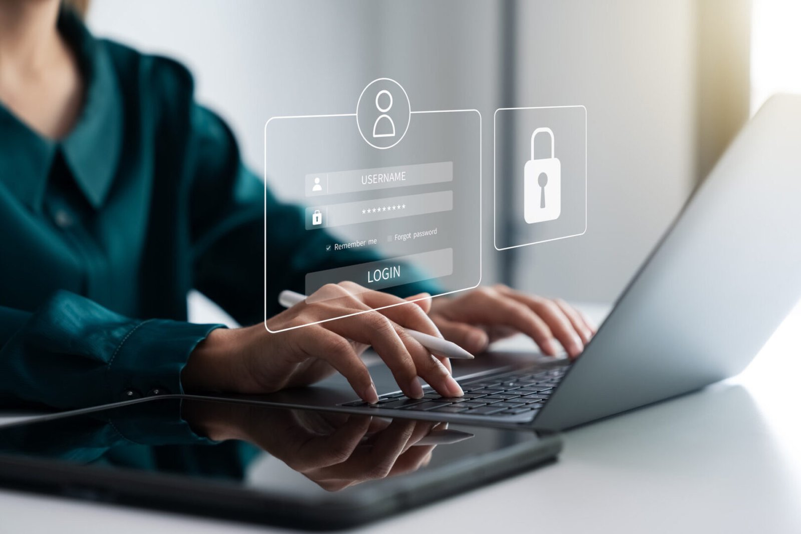 Person typing login credentials on laptop