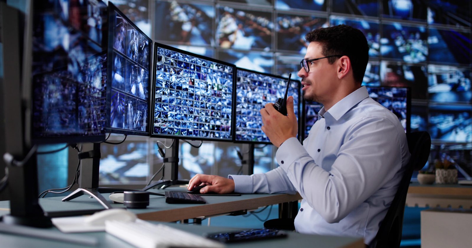 Security officer using multiple computer monitors
