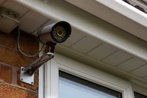 Mounted surveillance camera on building exterior