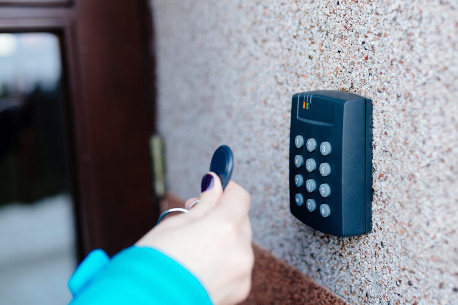 Person using keycard on security panel