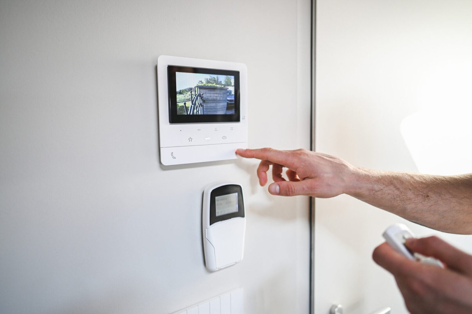 Person operating home security control panel.